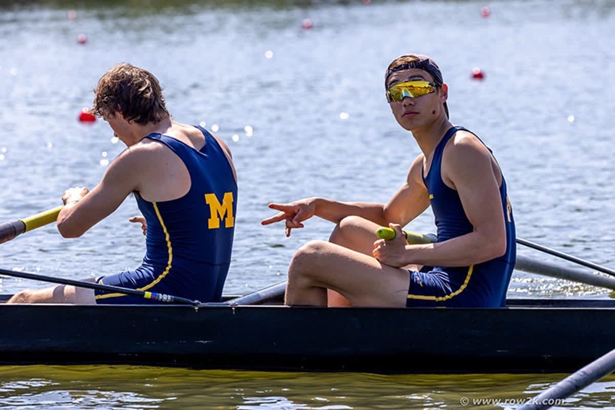 Two rowers in a pair, blades buried, on race day